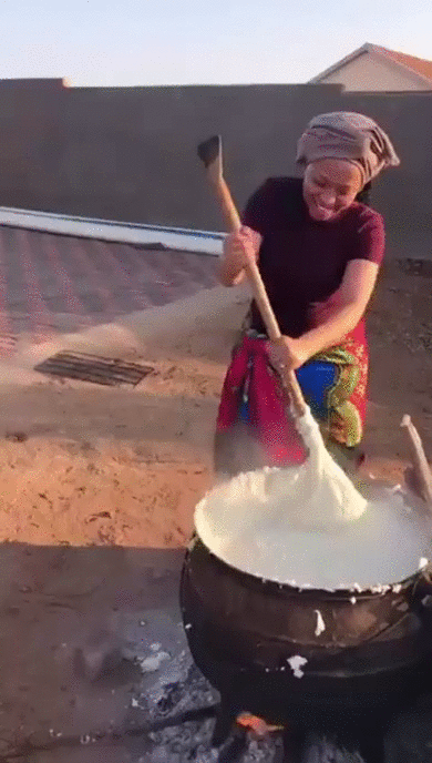 Woman cooking Pap before her wedding.